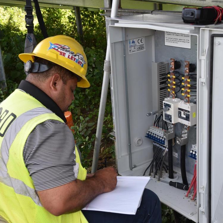 Employee working with electrical panel