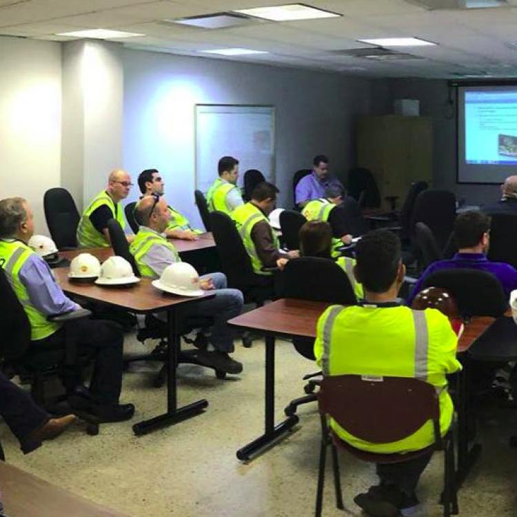 Employees viewing training briefing