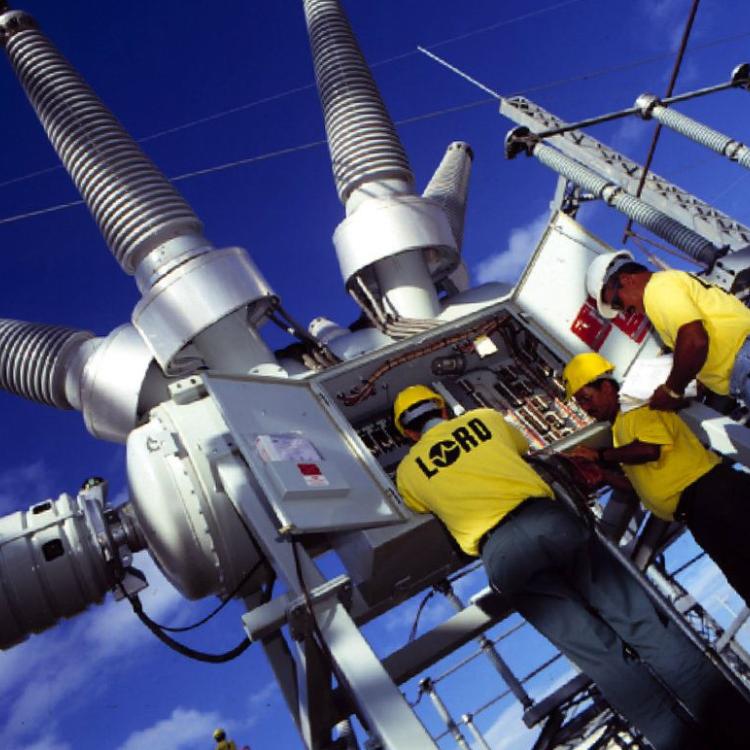 Workers configuring electrical panel