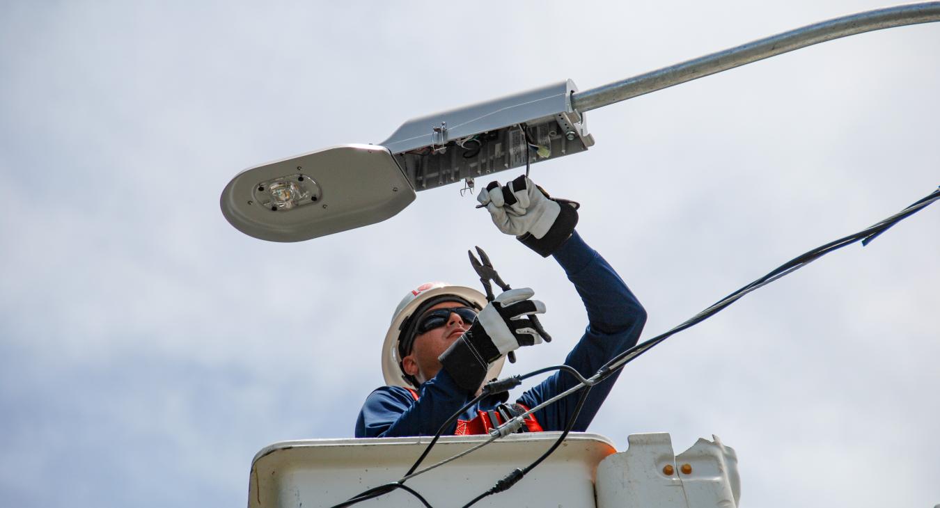 Worker fixing street light